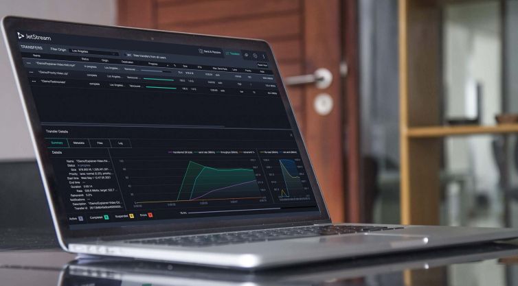 laptop computer on desk with jetstream incoming transfer